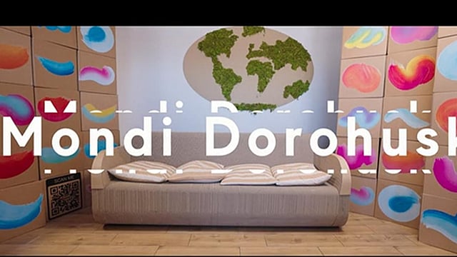 beige sofa with cushions set against a colourful background with the words Mondi Dorohusk on the screen